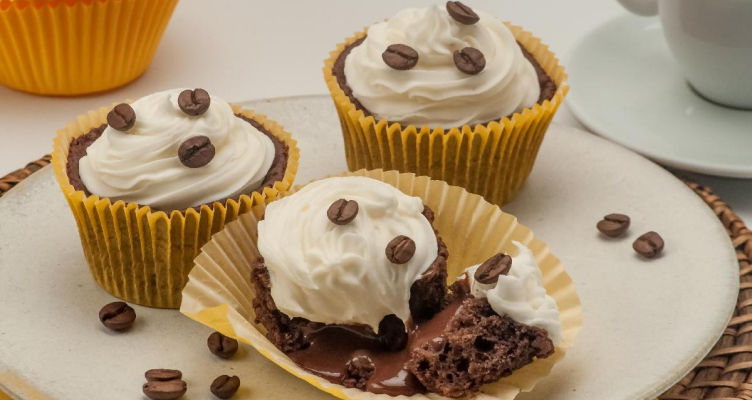 picture of a cupcake with coffee beans and whipped cream